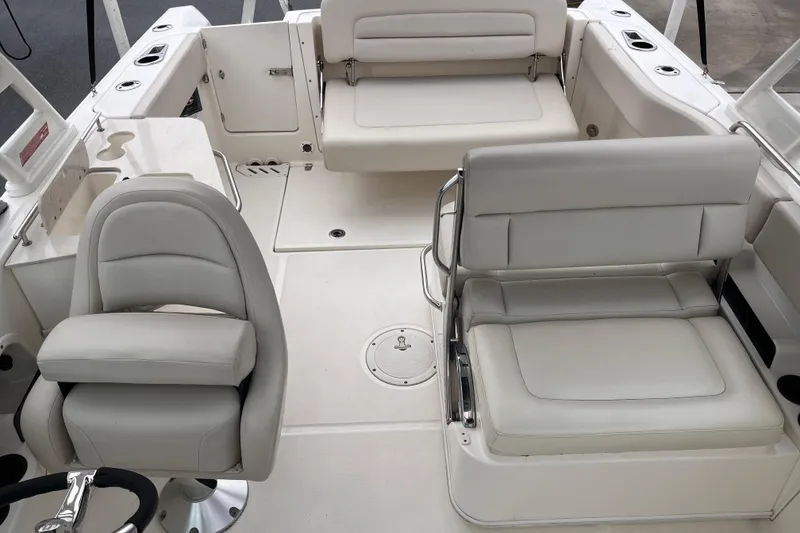 Slide: The Image of 2015 Boston Whaler 230 Vantage boat interior with white seating and steering wheel. - 21