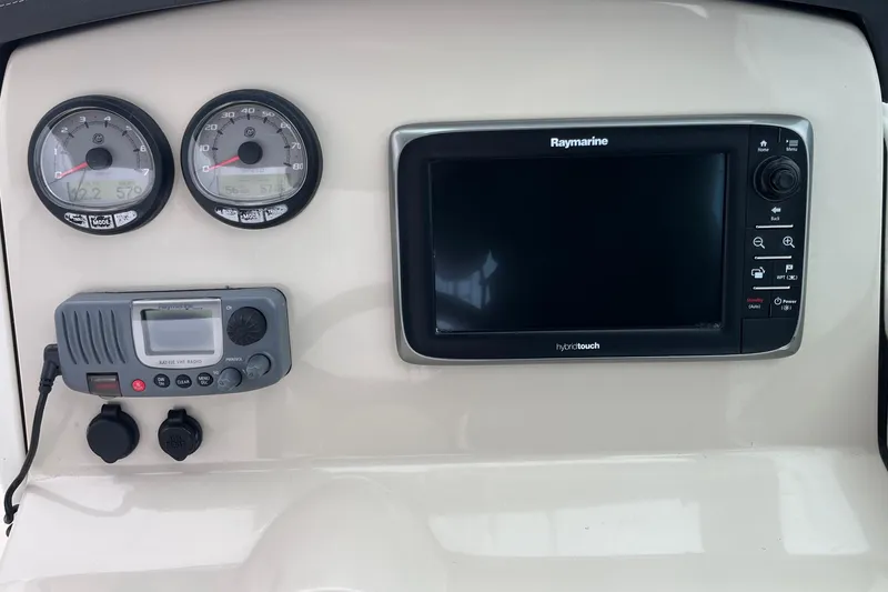 Slide: The Image of Dashboard of a 2015 Boston Whaler 230 Vantage with gauges and Raymarine display. - 23