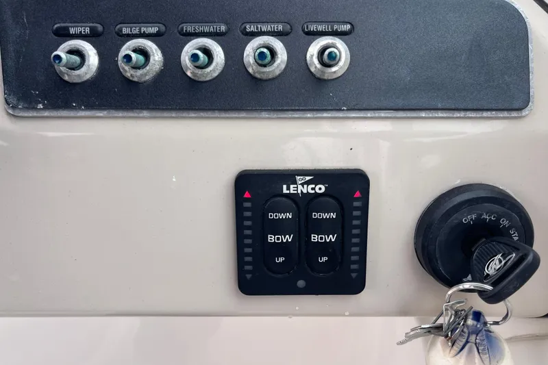 Slide: The Image of Control panel of a 2015 Boston Whaler 230 Vantage boat with switches and ignition. - 26