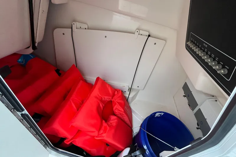 Slide: The Image of Interior of 2015 Boston Whaler 230 Vantage with life jackets and a blue bucket. - 27