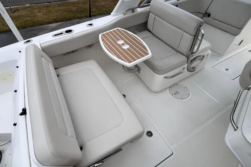Slide: The Image of 2015 Boston Whaler 230 Vantage boat interior with seating and table. - 28