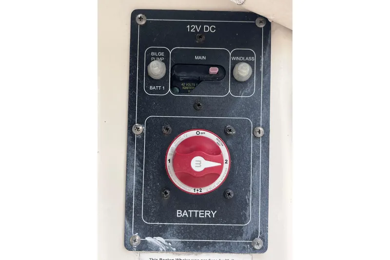 Slide: The Image of Control panel of a 2015 Boston Whaler 230 Vantage boat, featuring battery and switch controls. - 38