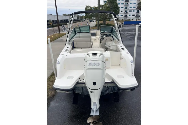 Slide: The Image of 2015 Boston Whaler 230 Vantage boat with powerful outboard motor, docked on wet pavement. - 42