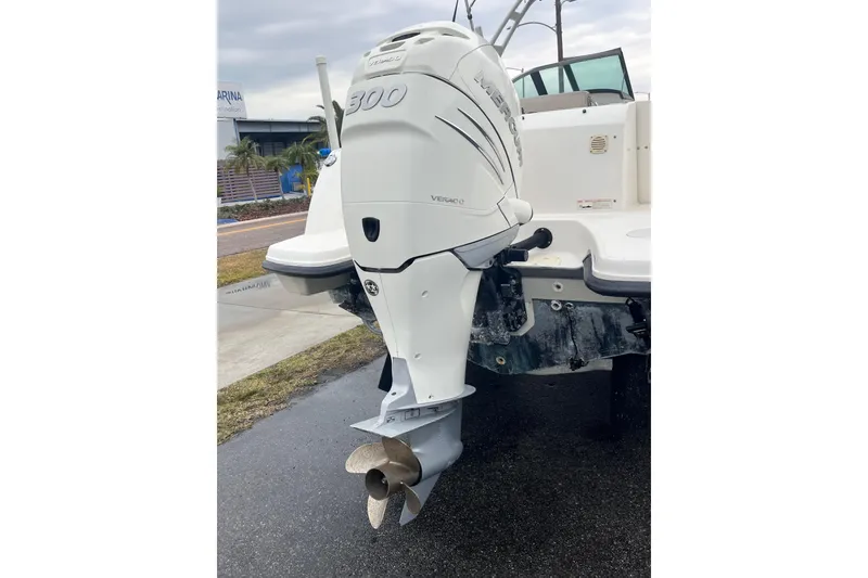 Slide: The Image of 2015 Boston Whaler 230 Vantage with Mercury 300 outboard engine, docked outdoors. - 8