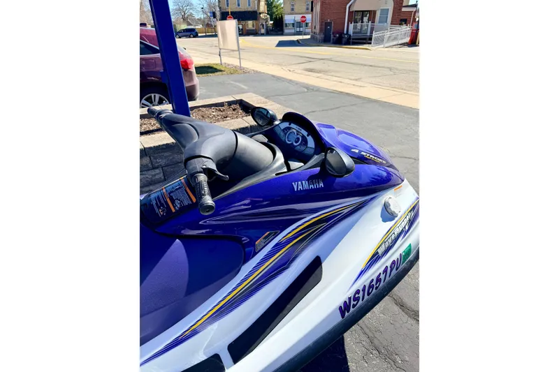 Slide: The Image of 2004 Yamaha WaveRunner FX Cruiser, blue and white, parked outdoors on pavement. - 14