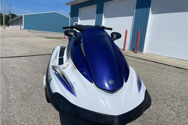 Slide: The Image of 2004 Yamaha FX 1000 jet ski with blue and white design, parked near blue buildings. - 3