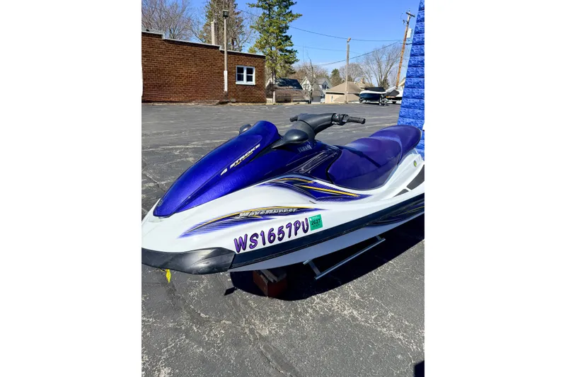 Slide: The Image of 2004 Yamaha WaveRunner FX Cruiser in blue and white, parked outdoors. - 9