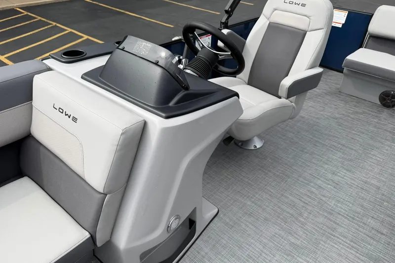Slide: The Image of Interior of 2026 Lowe LS 190 boat featuring modern seating and steering console. - 10