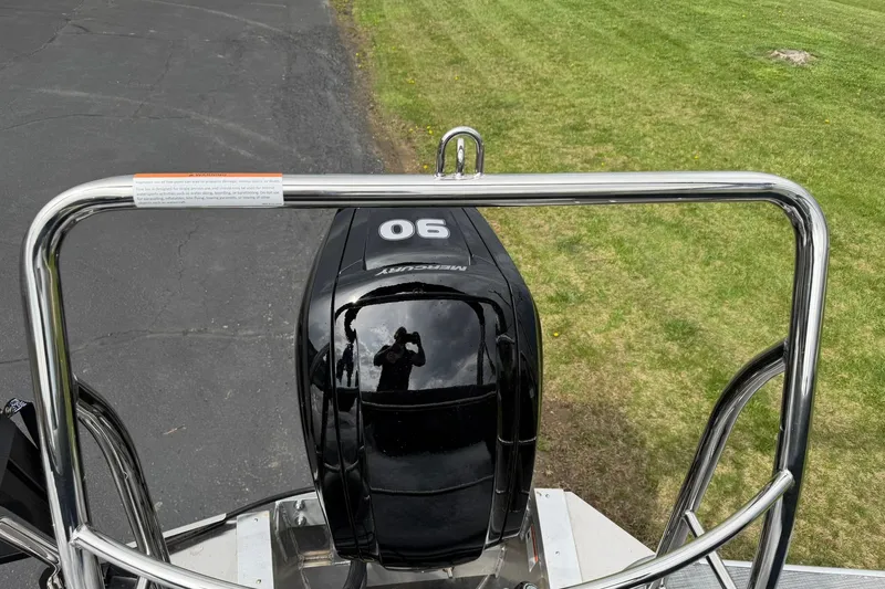 Slide: The Image of Rear view of a 2026 Lowe LS 190 boat with a Mercury 90 engine. - 20