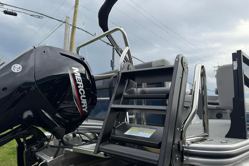 Slide: The Image of 2026 Lowe LS 190 boat with Mercury engine and ladder, under cloudy sky. - 22