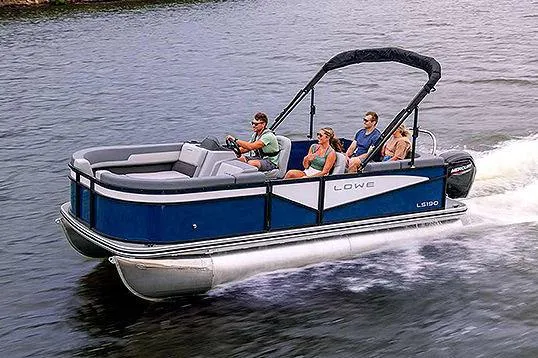 Slide: The Image of Manufacturer Provided Image: 2025 Lowe LS 190 pontoon boat cruising on a lake with passengers enjoying the ride. - 5