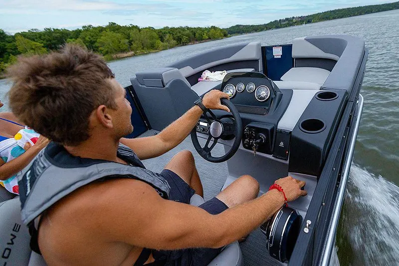 Slide: The Image of Manufacturer Provided Image: Man steering 2025 Lowe LS 190 boat on a scenic lake. - 6