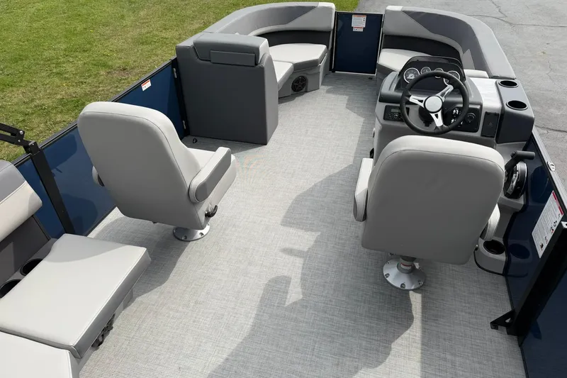 Slide: The Image of Interior of 2026 Lowe LS 190 pontoon boat with gray seating and steering console. - 8