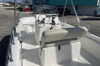 Slide: The Image of 2022 Boston Whaler 170 Montauk boat interior with steering console and seating. - 7