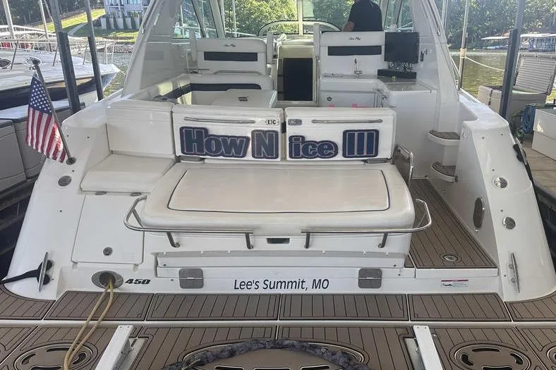 Slide: The Image of 2010 Sea Ray 450 Sundancer yacht docked, featuring "How Nice III" and American flag. - 11