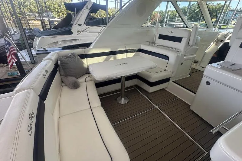 Slide: The Image of Luxurious 2010 Sea Ray 450 Sundancer yacht interior with plush seating and elegant table. - 12