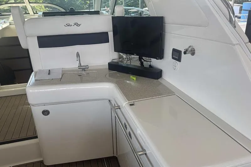 Slide: The Image of Interior of 2010 Sea Ray 450 Sundancer yacht with kitchenette and TV. - 13