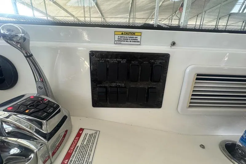 Slide: The Image of Control panel of a 2010 Sea Ray 450 Sundancer boat with switches and throttle. - 18