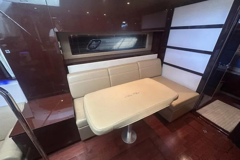 Slide: The Image of Interior of 2010 Sea Ray 450 Sundancer with beige seating and table. - 24