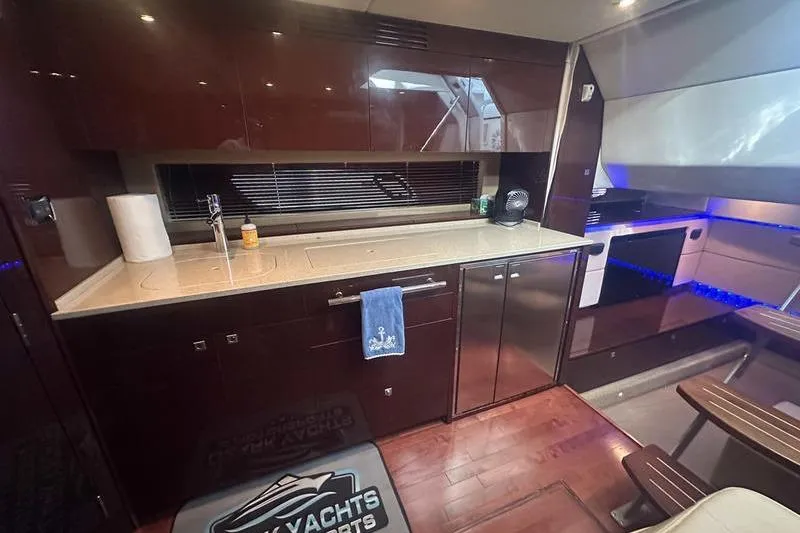 Slide: The Image of Luxurious 2010 Sea Ray 450 Sundancer yacht interior with modern kitchen amenities. - 25
