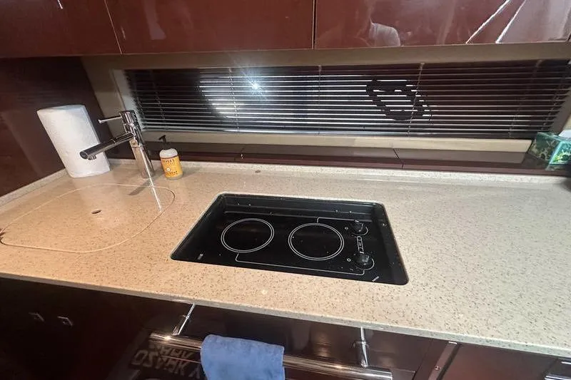 Slide: The Image of Modern kitchen in 2010 Sea Ray 450 Sundancer yacht with stovetop and sink. - 26