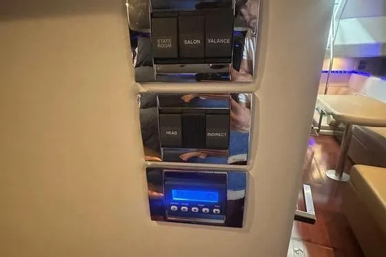 Slide: The Image of Control panel on 2010 Sea Ray 450 Sundancer yacht interior, featuring switches and digital display. - 30