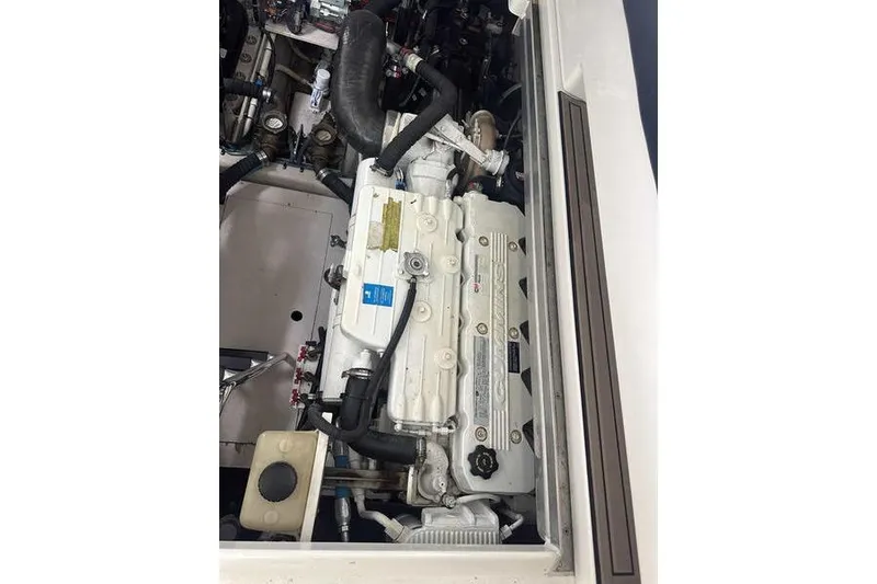 Slide: The Image of Engine compartment of 2010 Sea Ray 450 Sundancer boat, showcasing detailed mechanical components. - 38
