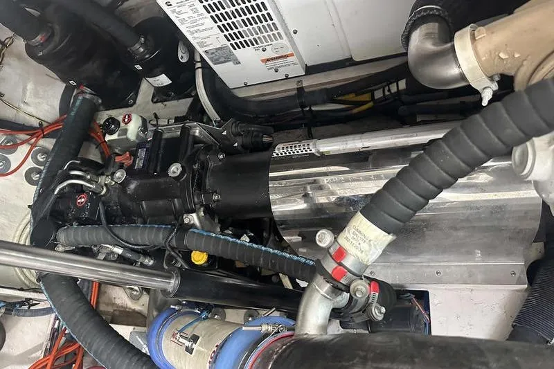 Slide: The Image of Engine compartment of a 2010 Sea Ray 450 Sundancer, showcasing mechanical components and hoses. - 40