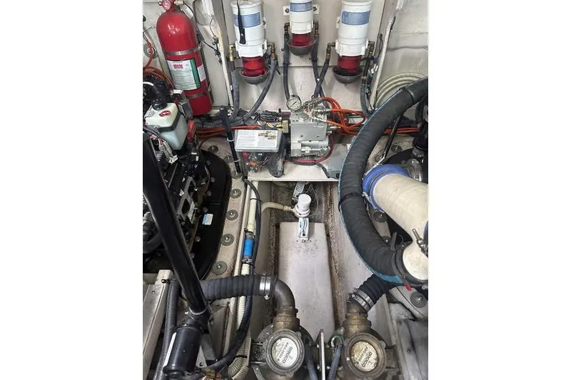 Slide: The Image of Engine room of 2010 Sea Ray 450 Sundancer with mechanical components and fire extinguisher. - 41