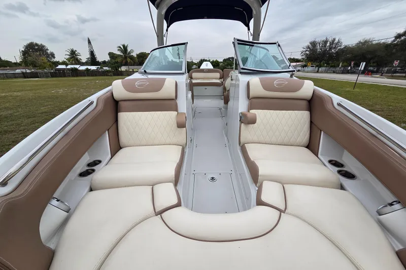 Slide: The Image of 2019 Crownline Eclipse E275 XS boat interior with beige and white seating. - 3