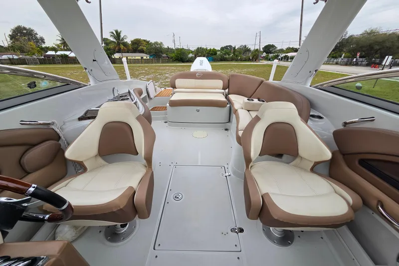Slide: The Image of 2019 Crownline Eclipse E275 XS boat interior with beige and white seating. - 6