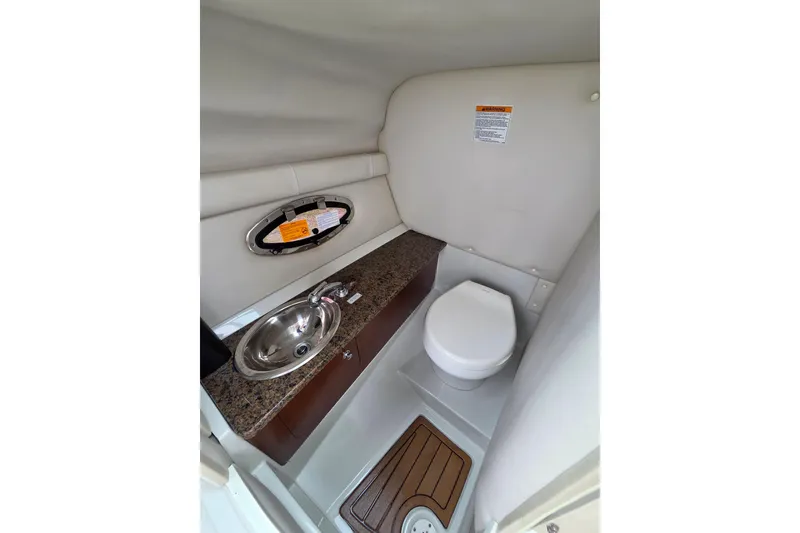 Slide: The Image of 2019 Crownline Eclipse E275 XS boat bathroom with sink and toilet. - 7