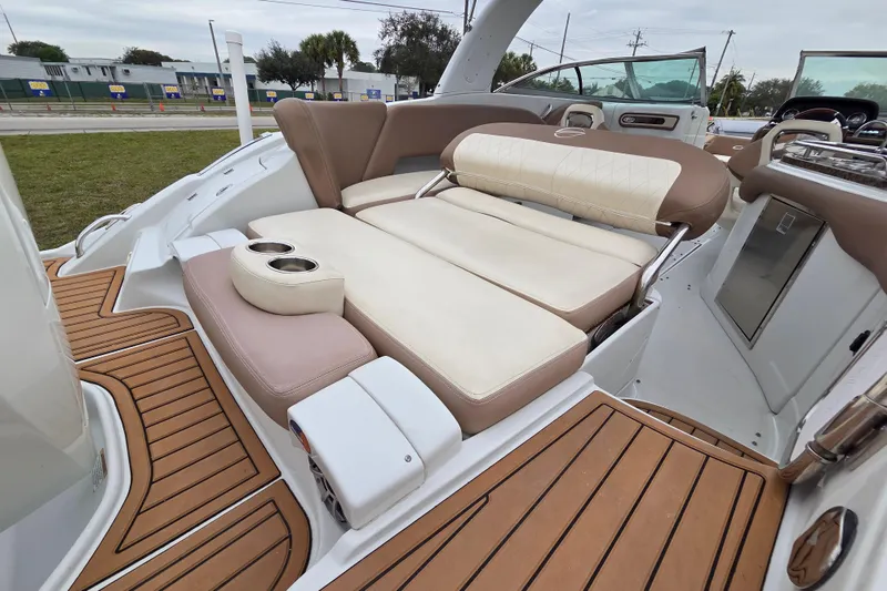 Slide: The Image of 2019 Crownline Eclipse E275 XS boat interior with luxurious seating and teak flooring. - 9