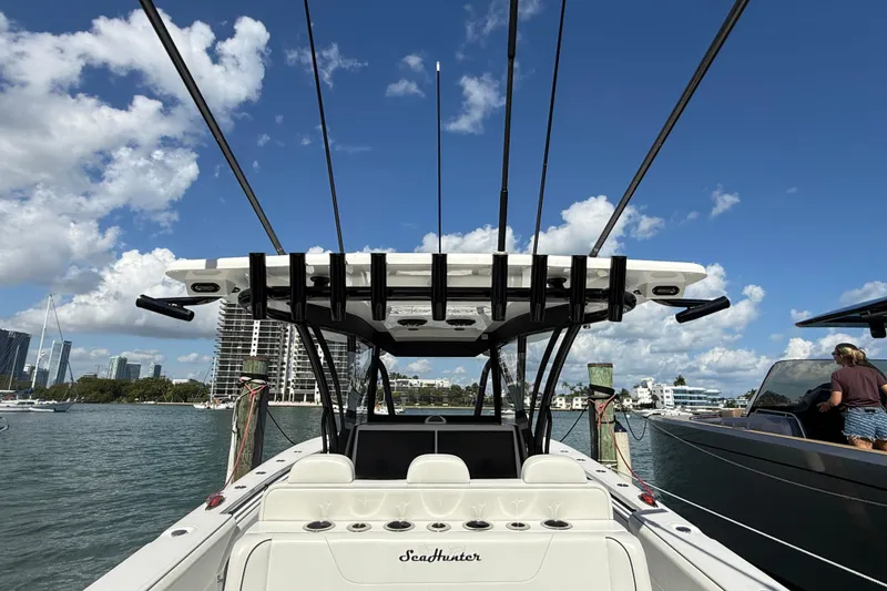 Slide: The Image of 2024 SeaHunter 35 Tournament boat docked, clear sky, city skyline in background. - 11