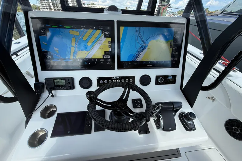 Slide: The Image of 2024 SeaHunter 35 Tournament helm with dual Garmin displays and advanced navigation controls. - 12