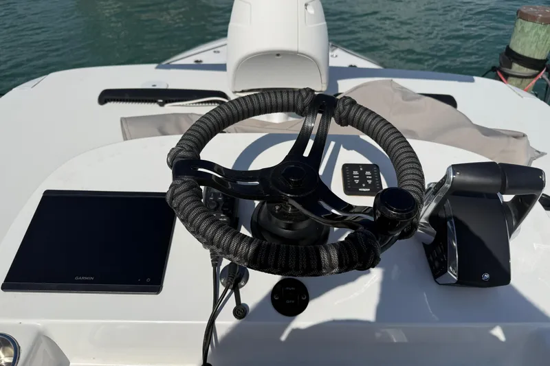 Slide: The Image of Helm of 2024 SeaHunter 35 Tournament boat with steering wheel and controls. - 16