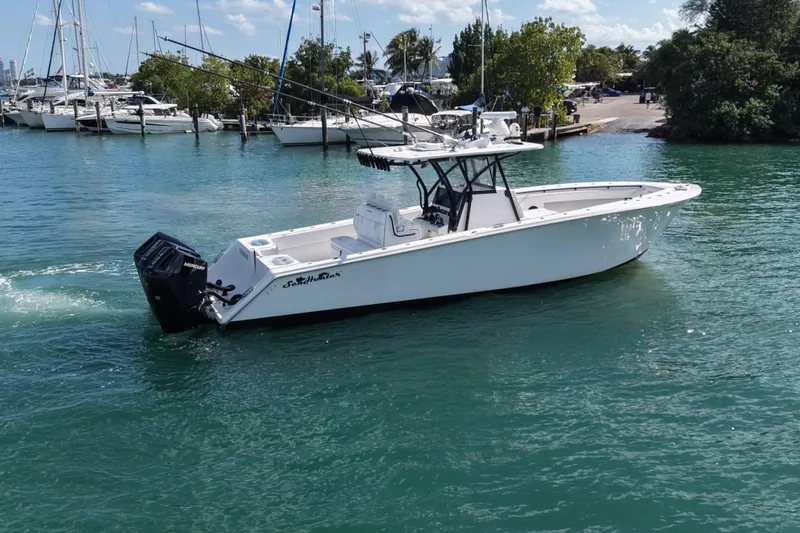 Slide: The Image of 2024 SeaHunter 35 Tournament boat cruising in a marina with clear blue water. - 2