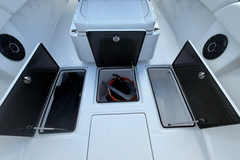 Slide: The Image of 2024 SeaHunter 35 Tournament boat storage compartments with open hatches and visible anchor. - 22