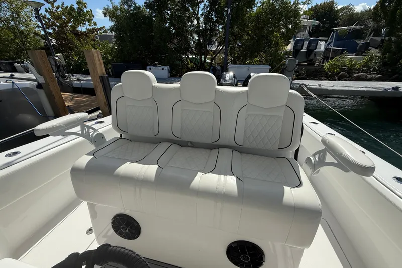 Slide: The Image of 2024 SeaHunter 35 Tournament boat with luxurious white seating and armrests, docked near water. - 24