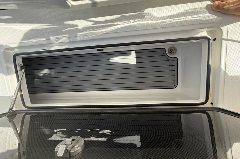 Slide: The Image of 2024 SeaHunter 35 Tournament boat storage compartment with open lid and hydraulic support. - 27