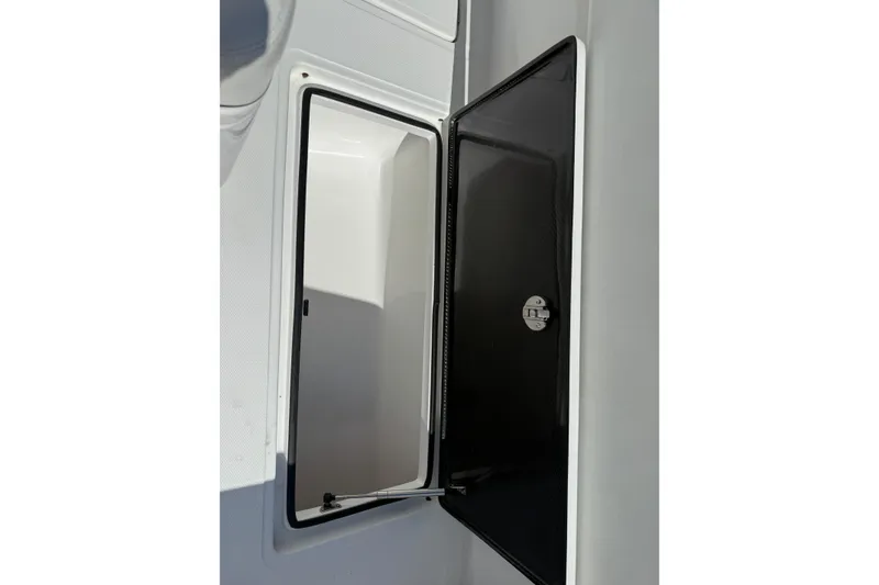 Slide: The Image of 2024 SeaHunter 35 Tournament storage compartment with open black door. - 30