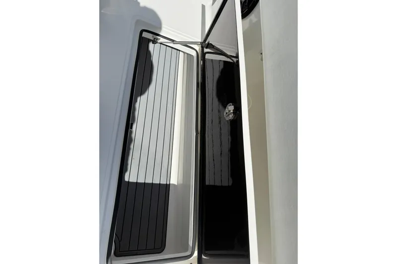 Slide: The Image of 2024 SeaHunter 35 Tournament boat storage compartment with sleek black interior. - 31