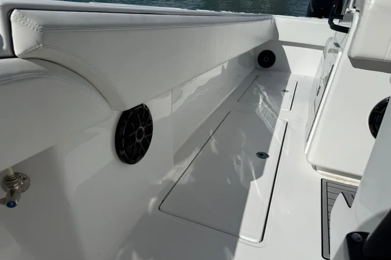 Slide: The Image of 2024 SeaHunter 35 Tournament boat interior with sleek white seating and built-in speakers. - 39