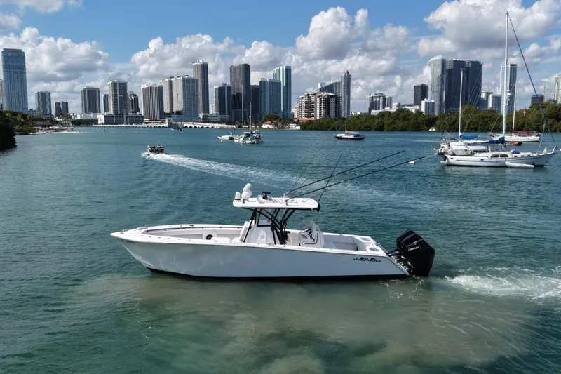 Slide: The Image of 2024 SeaHunter 35 Tournament boat cruising in urban waterfront with city skyline. - 4