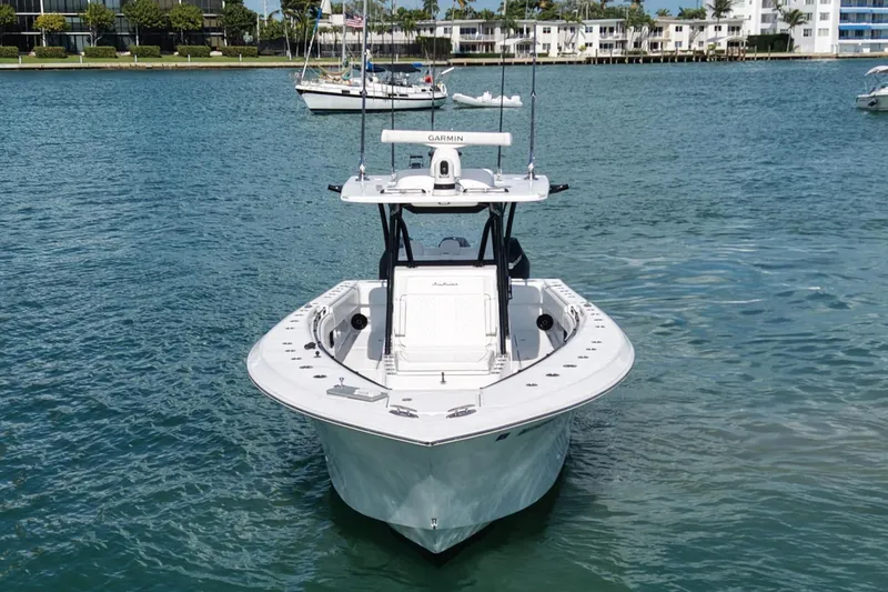 Slide: The Image of 2024 SeaHunter 35 Tournament boat on calm water, with coastal buildings in the background. - 5