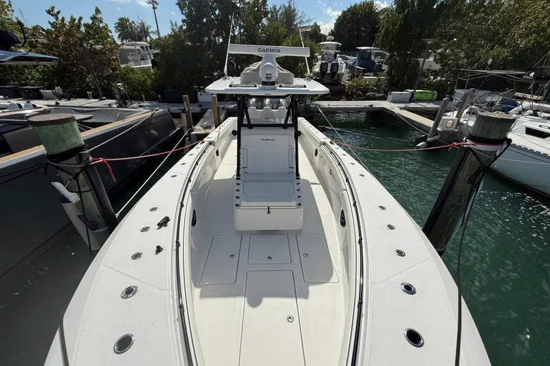 Slide: The Image of 2024 SeaHunter 35 Tournament boat docked, showcasing spacious deck and advanced navigation equipment. - 9