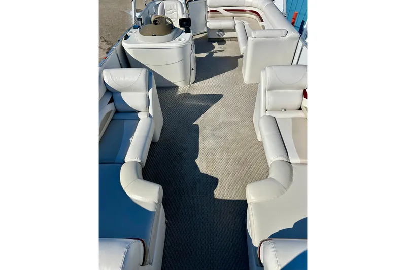 Slide: The Image of 2007 Crest LE 2270 pontoon boat interior with white seating and steering console. - 13