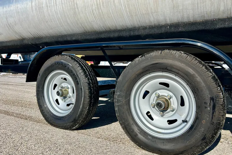 Slide: The Image of Trailer wheels of a 2007 Crest LE 2270 on asphalt surface. - 22