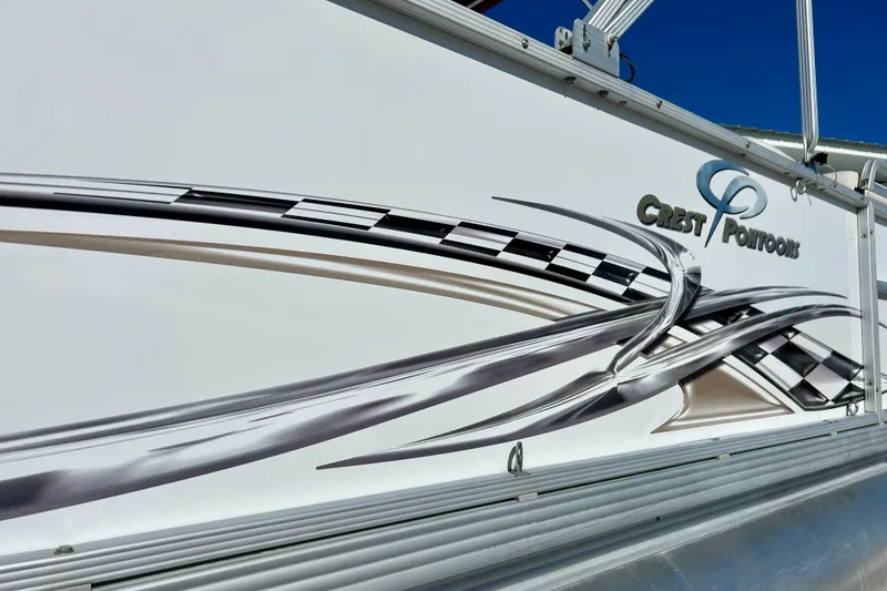 Slide: The Image of 2007 Crest LE 2270 pontoon boat with sleek graphics and logo design. - 23