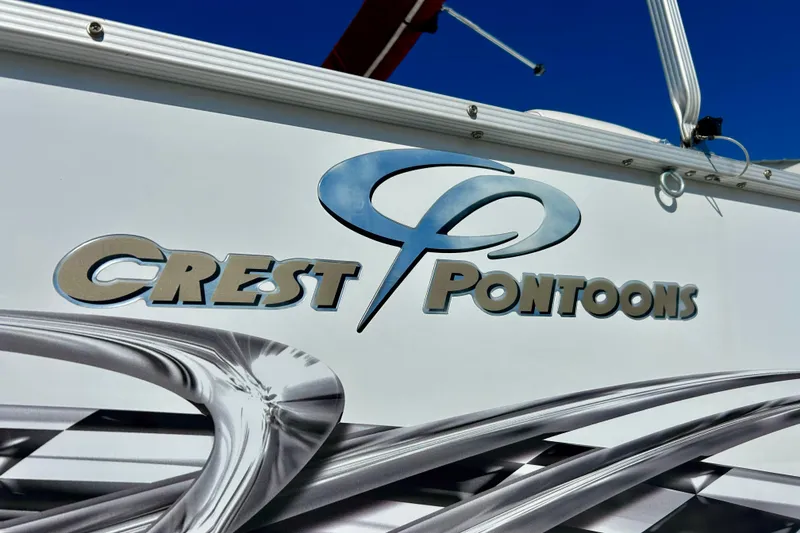 Slide: The Image of Crest Pontoons logo on a 2007 Crest LE 2270 boat, featuring sleek metallic design. - 24